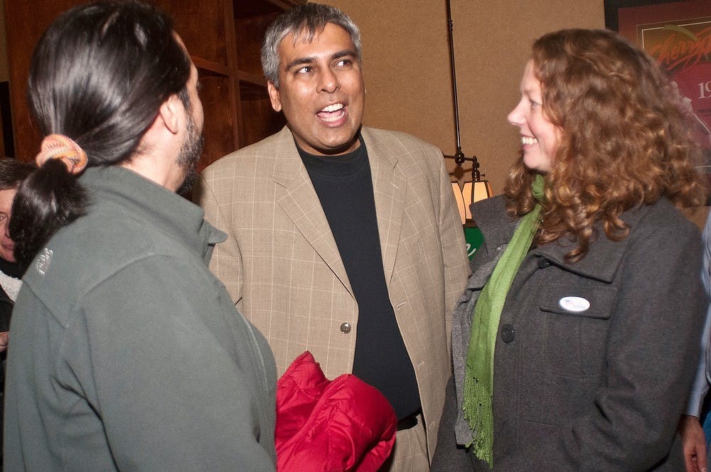 State representative candidate Sam Singh talks with friends and Lansing residents David Reyes-Gastelum (left) and Amy Jamison on Nov. 6, 2012, at The Pizza House for an election party. Katie Stiefel