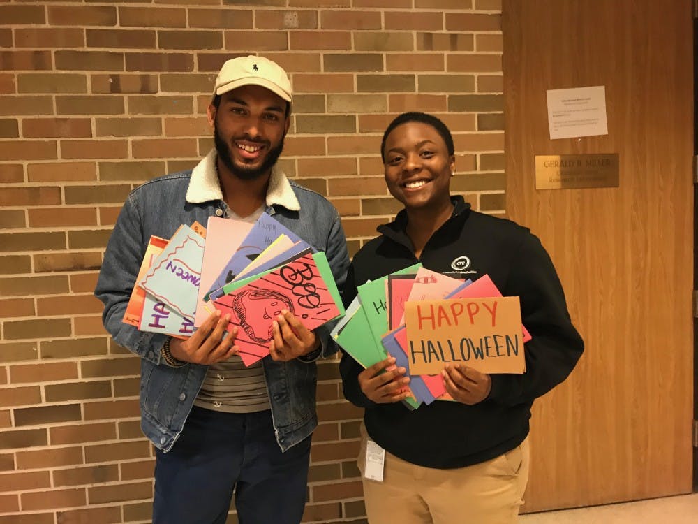 Tyler Logan and Yamani Vinson, holding some of the cards they have received in their Halloween card drive. Photo courtesy of Logan and Vinson.