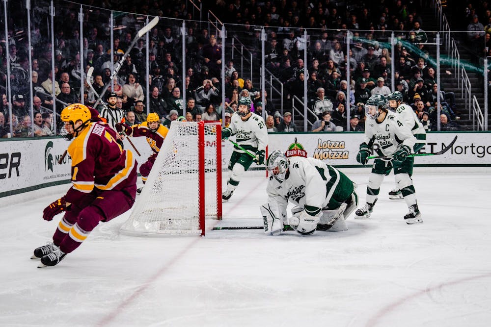 <p>Minnesota junior forward Aaron Huglen #7 flies by the goal after scoring against the Spartans at Munn Ice Arena on Jan. 27, 2024. The Spartans lost to the Gophers 5-1.</p>