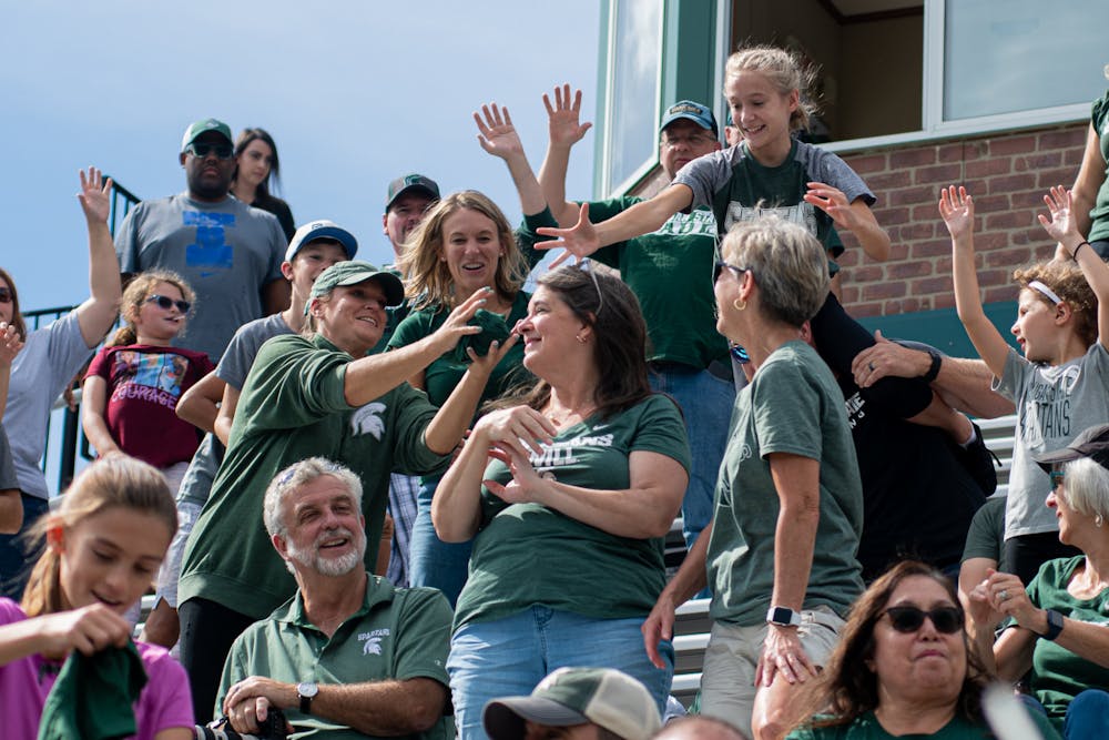 <p>Fans reach for t-shirts during the t-shirt toss. The Spartans defeated the Gophers 2-1 on Sept. 26, 2021.</p>