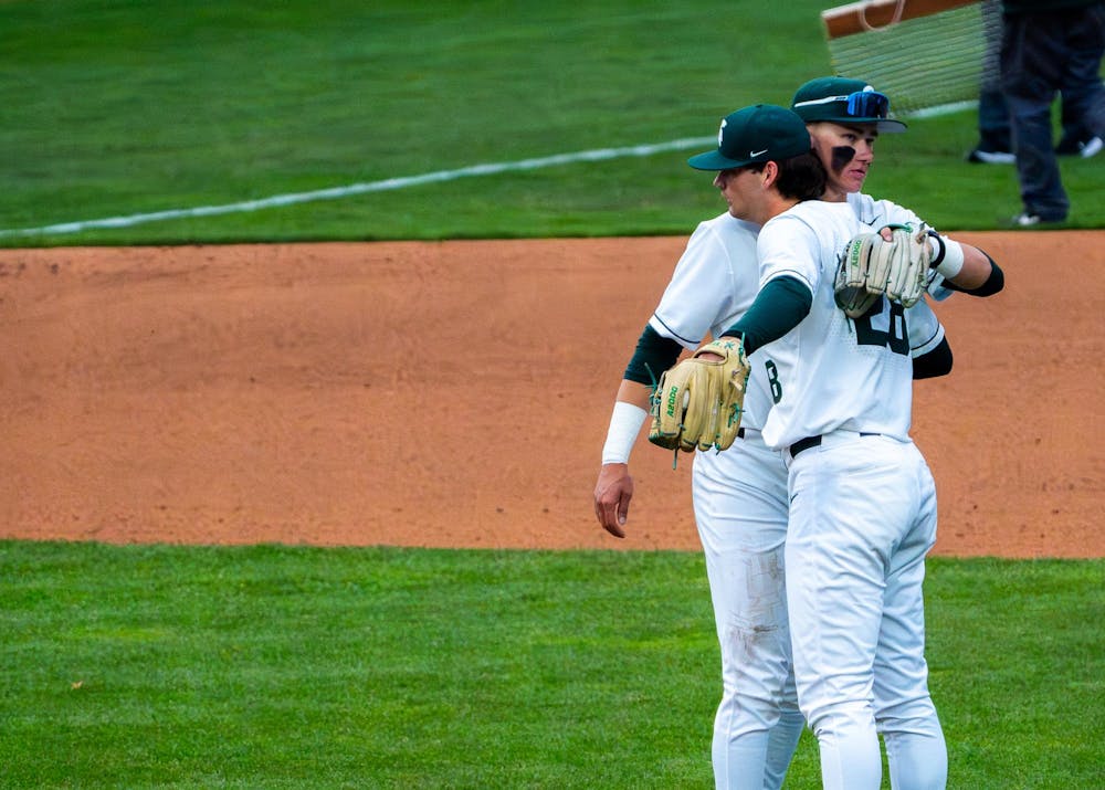 Michigan State third baseman CJ Deckinga, 13, and starting pitcher Aidan Donovan, 28, hug on the field during Michigan State’s game against Michigan at Jeff Ishbia Field at McLane Stadium in East Lansing, Mich., on Friday, April 10, 2026.