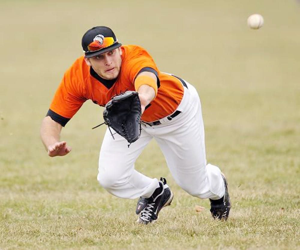 	<p>Jimmy Pickens of Brother Rice High School attempts to make a catch in an April game against Divine Child High School. Pickens has committed to play with the Spartans next year, but after being drafted by the Detroit Tiger, he will have to choose between the two teams if the Tigers offer him a contract.</p>
