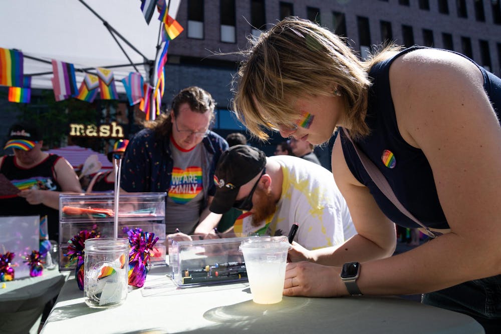 <p>Rooted Counseling invites people at East Lansing Pride to draw on a square to put onto a community quilt in East Lansing, Mich., on June 13, 2026.</p>