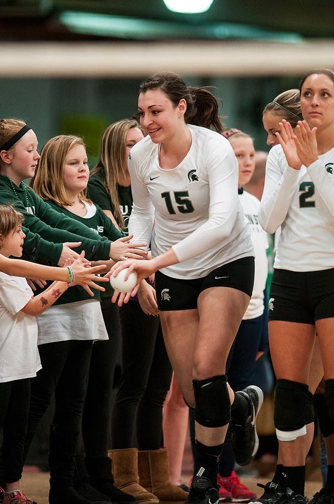 	<p>Senior outside hitter Lauren Wicinski high-fives some young fans before the game against Minnesota on Nov. 23, 2013, at Jenison Field House. The Spartans lost to the Golden Gophers, 3-1. Khoa Nguyen/The State News </p>