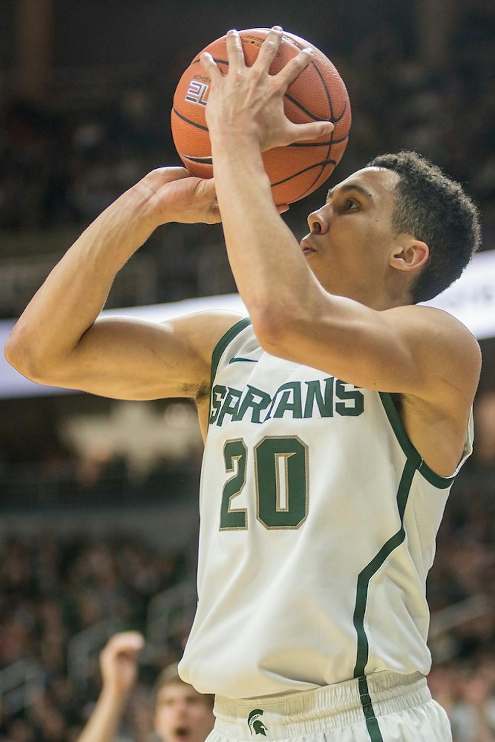 <p>Senior guard Travis Trice attempts a point Jan. 5, 2015, during the game against Indiana at Breslin Center. The Spartans defeated the Hoosiers, 70-50. Erin Hampton/The State News</p>
