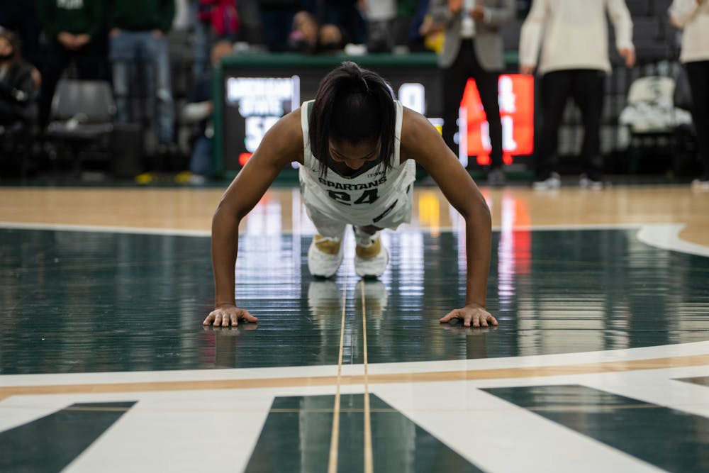 <p>Senior guard Nia Clouden (24) kisses the Spartan head at the Breslin Center. The Spartans held a ceremony honoring the four graduating seniors of the women&#x27;s basketball team on Feb. 27, 2022. </p>