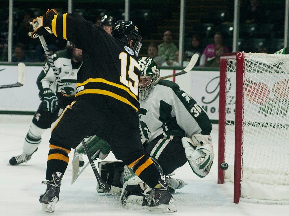 	<p>Sophomore goaltender Jake Hildebrand allows a goal from American International forward Blake Peake on Nov. 1, 2013, at Munn Ice Arena. The Spartans beat the Yellow Jackets, 5-4. Danyelle Morrow/The State News</p>