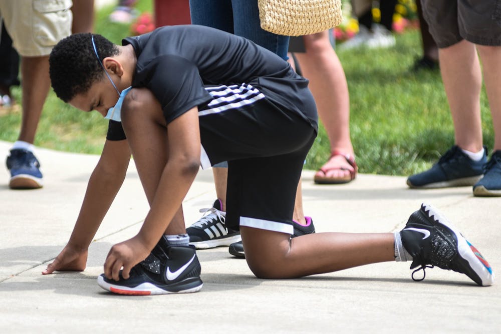 A protester kneels at the protest against police brutality at the Michigan State Capitol on June 10, 2020.