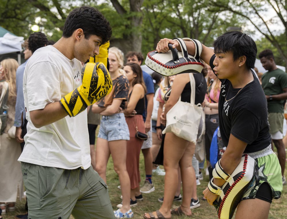 <p>Students watch trainer Immanuel Corla in MMA Club during Sparticipation on Tuesday, Aug. 30, 2022 at Michigan State University.</p>