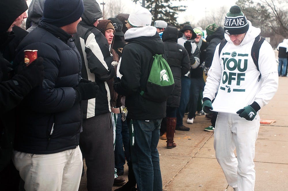 	<p>Brighton, Mich., resident and creator of the &#8220;You Off&#8221; T-shirts Chris Walker shows off his shirt in an attempt to increase sales to students waiting in line outside Breslin Center on Tuesday. Walker first started selling the T-shirts at the <span class="caps">MSU</span> vs. U-M game in order to make fun of the U-M &#8220;We On&#8221; T-shirts. Danyelle Morrow/The State News</p>