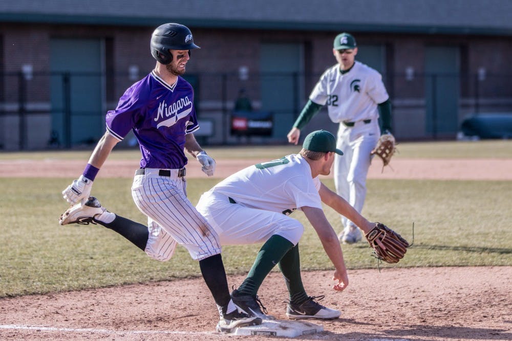 <p>Sophomore relief pitcher Mike Momka (20) covers first on a double play during the game against Niagara on March 16, 2018 at McLane Baseball Stadium. The Spartans fell to the Purple Eagles, 3-2.</p>