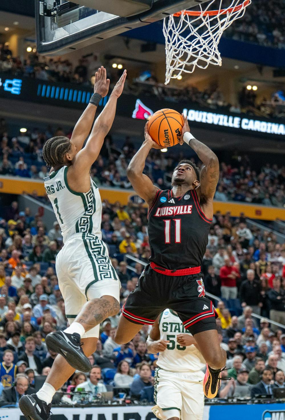Redshirt Sophomore point guard Jeremy Fears Jr. (1) attempts to block an opposing player during the March Madness matchup against University of Louisville at the KeyBank Center in Buffalo, New York on March 21, 2026.