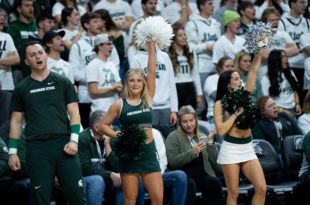 The MSU cheerleading team cheers for the men's basketball team during a game against Villanova at the Breslin Center on Nov. 18, 2022. The Spartans defeated the Wildcats 73-71. 