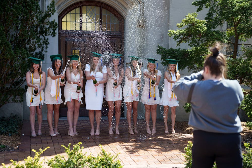 2022 graduating seniors appear to be taking pictures by the Beaumont Tower to celebrate graduation, on May 4, 2022. 