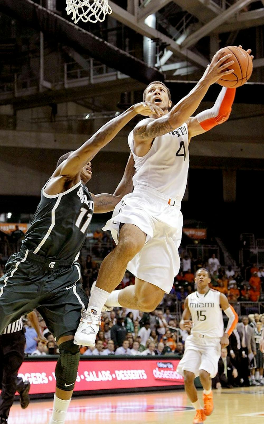 	<p>Miami&#8217;s Julian Gamble, right, drives pass Michigan State&#8217;s Keith Appling in the second half at the BankUnited Center on Wednesday, November 28, 2012, in Coral Gables, Florida. The Miami Hurricanes defeated the Michigan State Spartans, 67-59. Carl Juste/Miami Herald/MCT</p>
