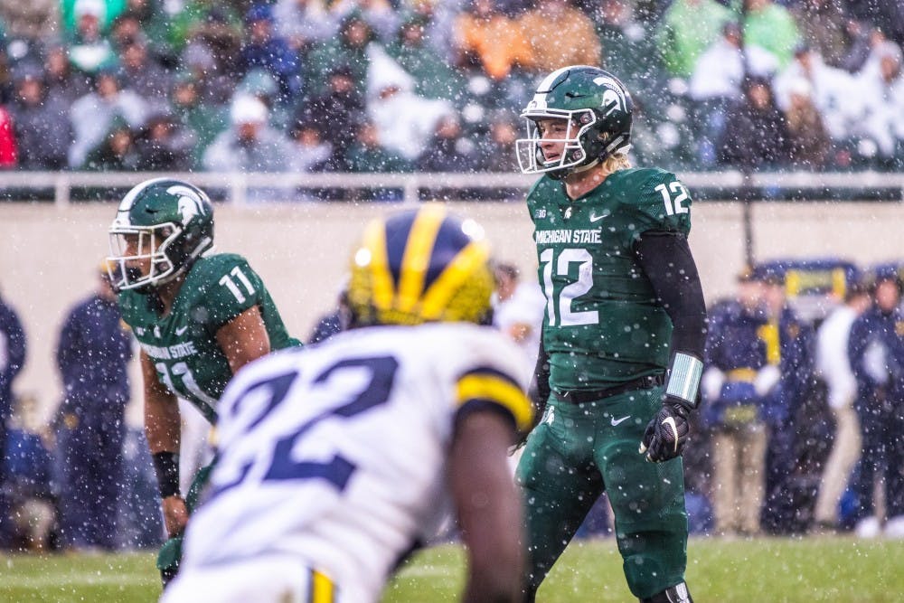 Redshirt freshman quarterback Rocky Lombardi (12) stands behind center during the game against Michigan at Spartan Stadium Oct. 20. The Wolverines defeated the Spartans, 21-7.