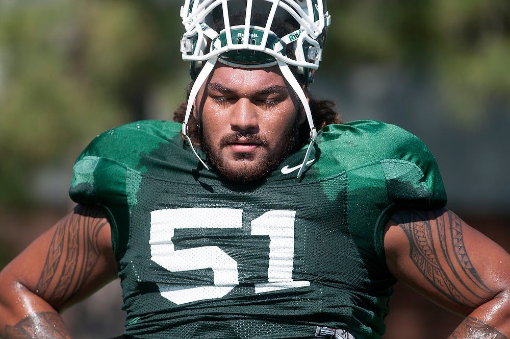 	<p>Senior offensive tackle Fou Fonoti takes a break during practice Aug. 9, 2013, at the practice field outside Duffy Daugherty Football Building. Fonoti and the Spartans are returning to Fonoti&#8217;s home state to take on Stanford in the Rose Bowl on New Year&#8217;s Day. Julia Nagy/The State News</p>