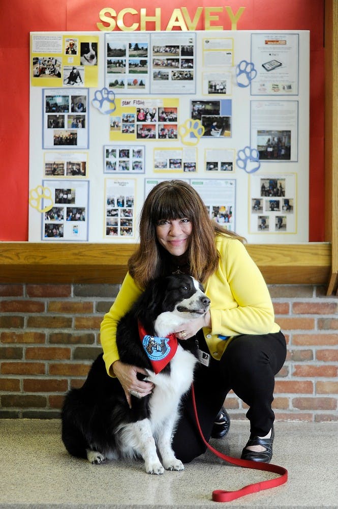 	<p>Judy Winter poses with her dog Jack at Schavey Road Elementary School in May. Photo courtesy of Jena McShane </p>