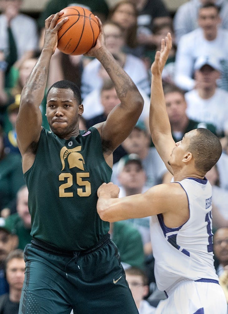 Senior center Derrick Nix holds the ball after getting a rebound as Northwestern guard Reggie Hearn defends him. The Spartans defeated the Wildcats, 71-61, on March 10, 2013, at Breslin Center. Justin Wan/The State News