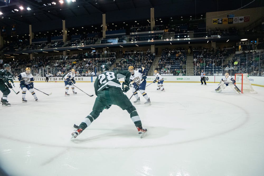 <p>Spartan freshman forward Karsen Dorwart looks to make a play while Notre Dame junior defenseman Drew Bavaro anticipates his moves at Compton Family Ice Arena in Notre Dame, IN on Friday, March 3, 2023. The Spartans fell to the Fighting Irish 1-0 in the Friday night matchup.</p>