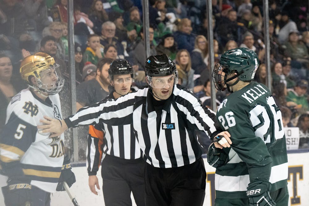 <p>A referee separates Notre Dame graduate student defenseman Chase Blackmun (left) from MSU sophomore forward Tanner Kelly at Compton Family Ice Arena in Notre Dame, IN on Friday, March 3, 2023. The Friday night matchup featured a few scrums and 10 penalty minutes assessed.</p>