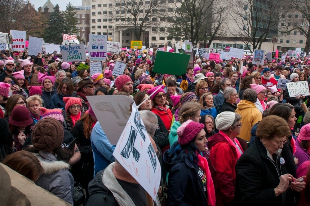Protesters gather outside of the capitol to listen to speeches during the Women's March on Lansing on Jan. 21, 2017 at the Capital Building in Lansing. Activists gathered and expressed their opinions through peaceful demonstration.