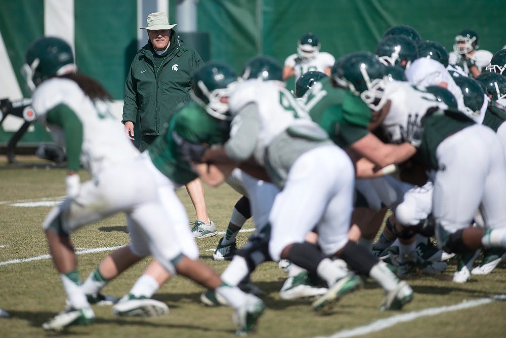 <p>Co-offensive coordinator/tight ends coach Jim Bollman watches the Spartans during football practice April 8, 2014, at the practice field outside Duffy Daugherty Football Building. Julia Nagy/The State News</p>
