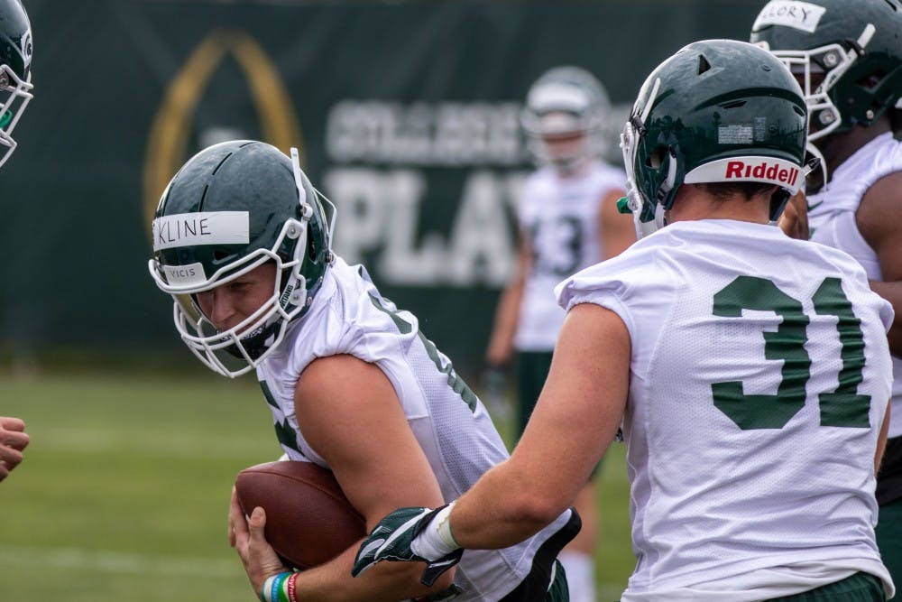 <p>Freshman linebacker Edward Warriner (31) runs through a defensive drill in practice on Aug. 2, 2018 at Duffy Daugherty Football Building.</p>