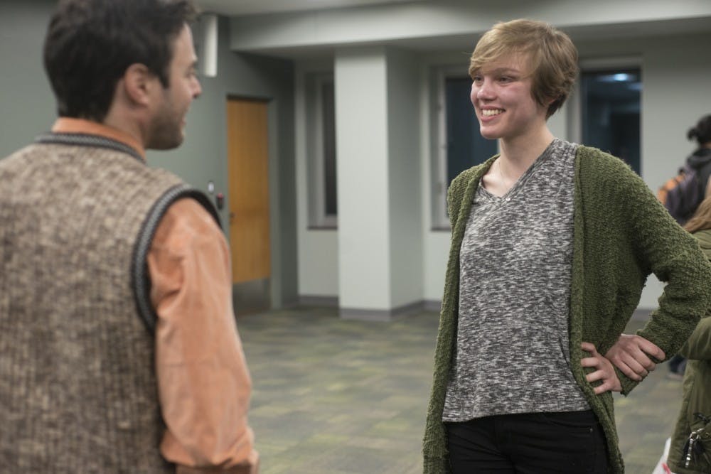 English senior Anna Goodson talks to American writer Matthew G. Frank on March 23, 2016 in the Green Room at the MSU Main Library. Goodson received the first place award for her entries in poetry, fiction, non-fiction, and flash fiction.