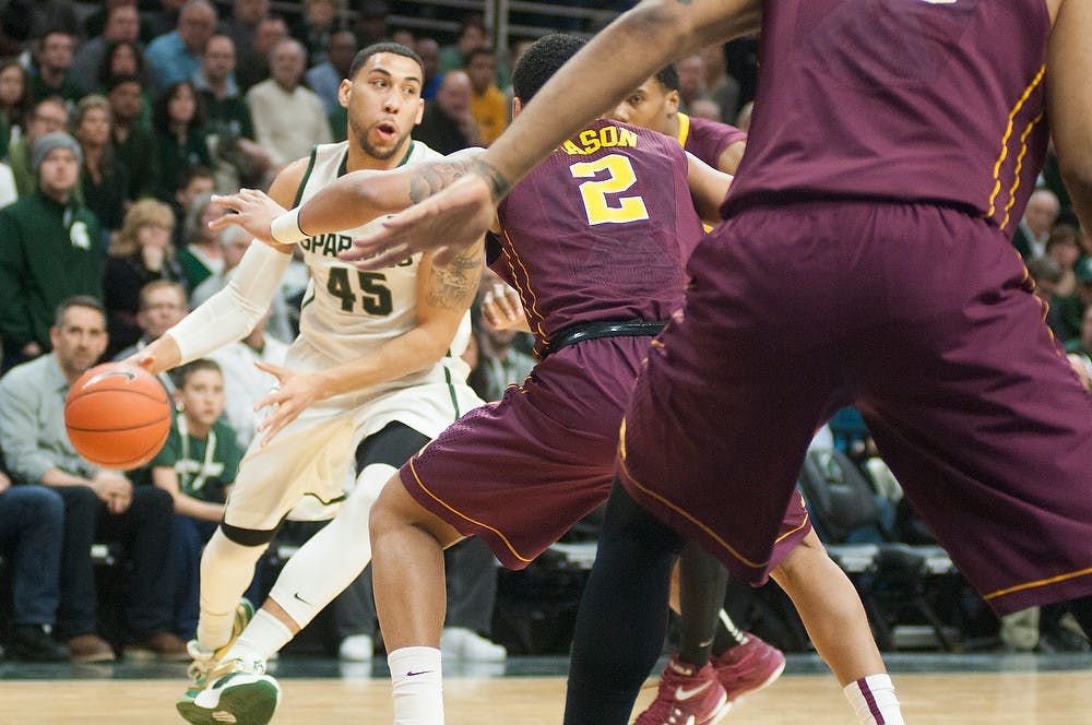 <p>Junior guard Denzel Valentine dribbles the ball past Minnesota guard Nate Mason Feb 26, 2015, during the game against Minnesota at Breslin Center. Kennedy Thatch/The State News</p>