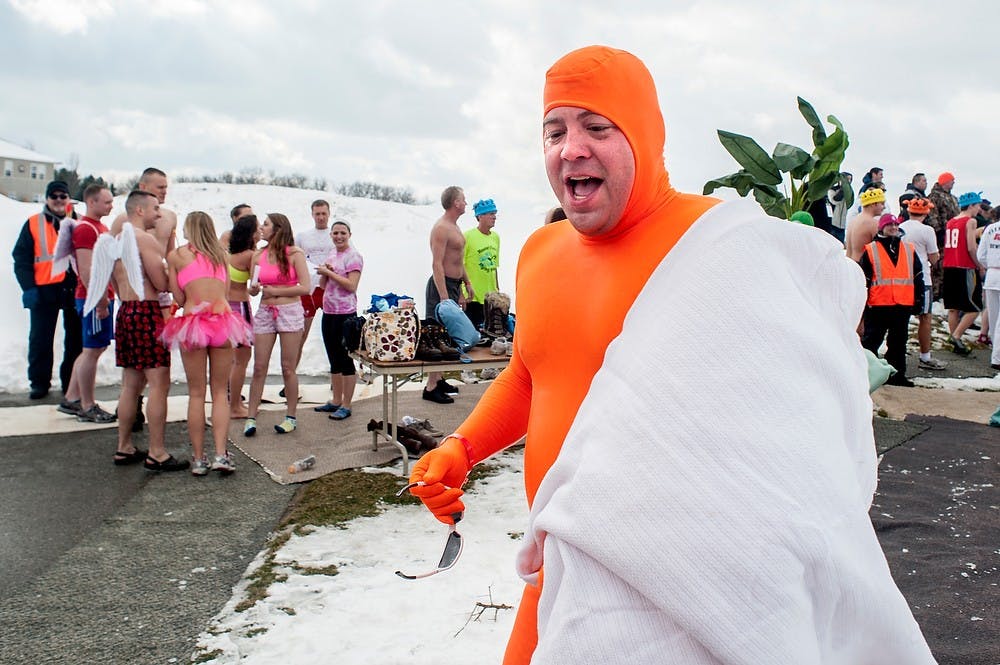 	<p>Lansing resident Tim Schmitt rushes back to the changing room after his turn at Lansing Polar Plunge, Sunday, Feb. 24, 2013, at Eagle Eye Golf Club in Bath, Mich. The event was a charity drive to raise money for Special Olympics.</p>