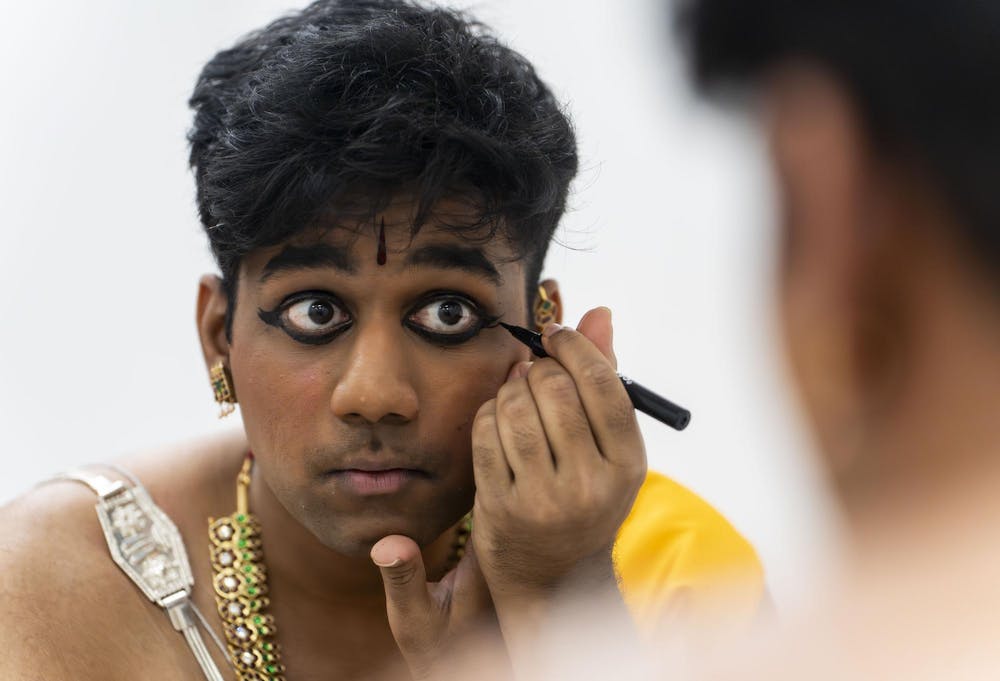 Abhinav Anand puts on makeup before his performance at the Shivaratri festival. As a man in dance, performance makeup doesn't come as naturally for Anand. “I suck at makeup, but I have to learn how to put makeup on,” he said. “You need to be presentable because if you're not presentable no one's going to look at you.” 