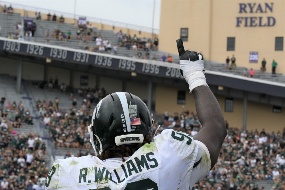 <p>Senior defensive tackle Raequan Williams (99) celebrates after the game against Northwestern on Sept. 21, 2019 at Ryan Field. MSU defeated Northwestern, 31-10.</p>