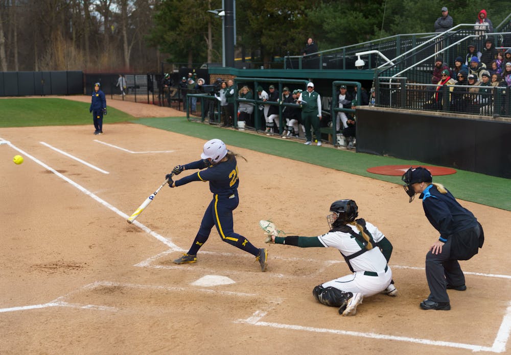 <p>Michigan senior Hannah Carson (20) hits a double to left-center in the top of third inning. Michigan State lost 3-0 to Michigan at the Secchia Stadium, on April 19, 2022.</p>