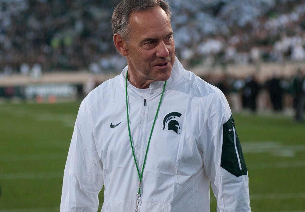 <p>MSU football coach Mark Dantonio walks on the field before the game against Oregon on Sept. 12, 2015 at Spartan Stadium. The Spartans defeated the Ducks 31-28. Joshua Abraham/The State News</p>