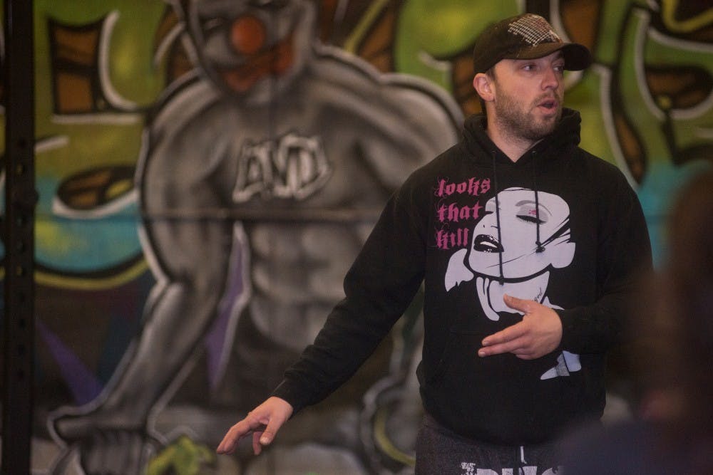 <p>East Lansing resident and Spartan CrossFit owner Michael Horton instructs a class during a CrossFit training workout on Nov. 21, 2015 at Spartan CrossFit on 4150 Hunsaker Street in East Lansing. Many students utilize this facility which focuses on strength training and conditioning. </p>