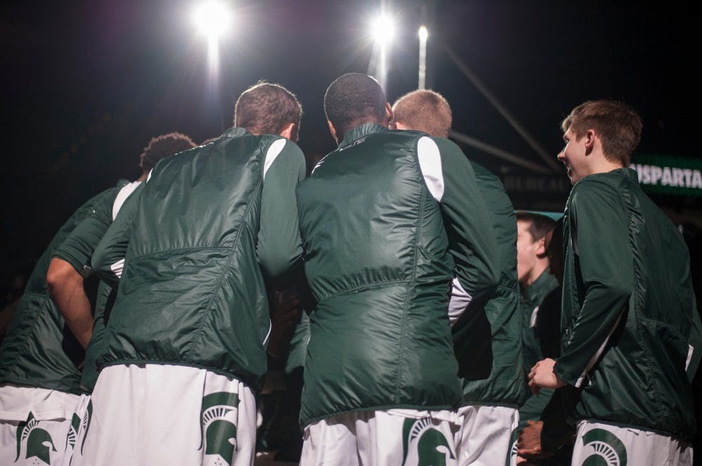 The Spartans huddle at the beginning of the game against Wisconsin on Feb. 18, 2016 at Breslin Center. The Spartans defeated the Badgers, 69-57.