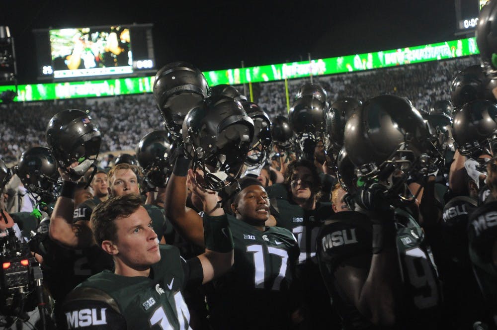 <p>The Michigan State football team chants the MSU fight song along with fans and the band after the game against Oregon on Sept. 12, 2015 at Spartan Stadium. The Spartans defeated the Ducks 31-28. Joshua Abraham/The State News</p>