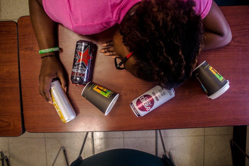 <p>Psychology and criminal justice senior Brianna Harris rests her head on a desk on Oct. 10, 2018 at Berkey Hall. Balancing work, school and a social life is a challenge for many college students and can result in sleep deprivation.   </p>
