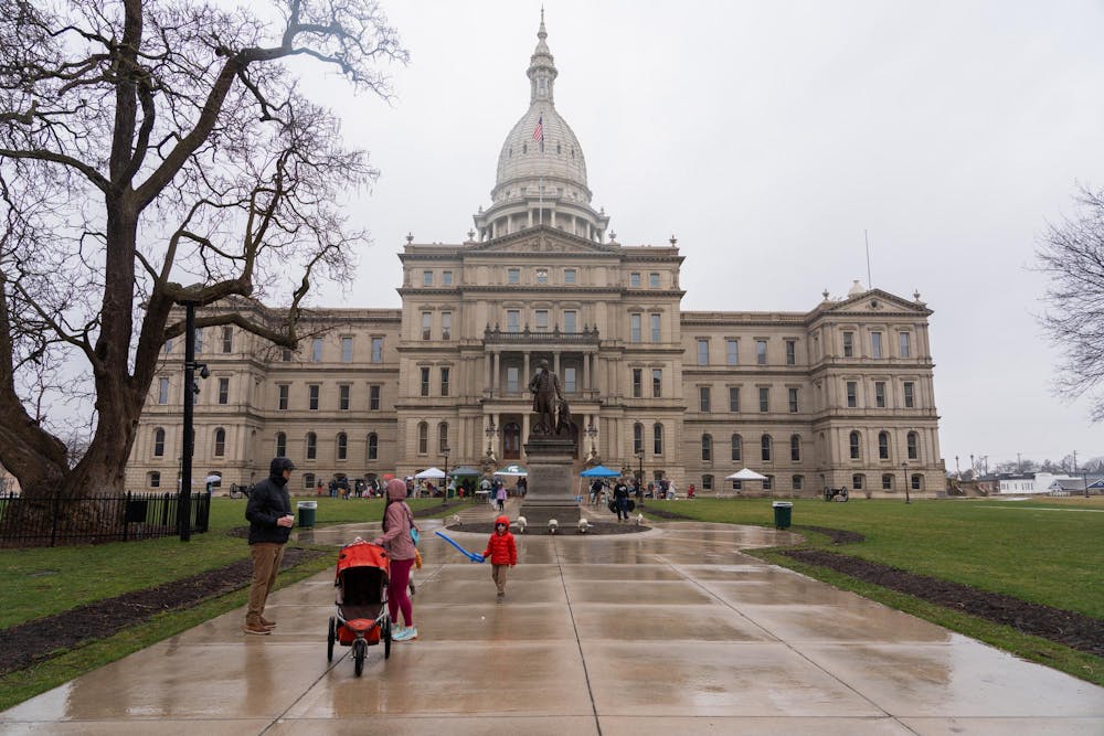<p>The Michigan Capitol building on Saturday, March 30, 2024. Families braved the rain to participate in an Easter egg hunt hosted by JCI Lansing on the capitol lawn, including balloon animals, snacks and drinks and photo opportunities with the Easter Bunny.</p>