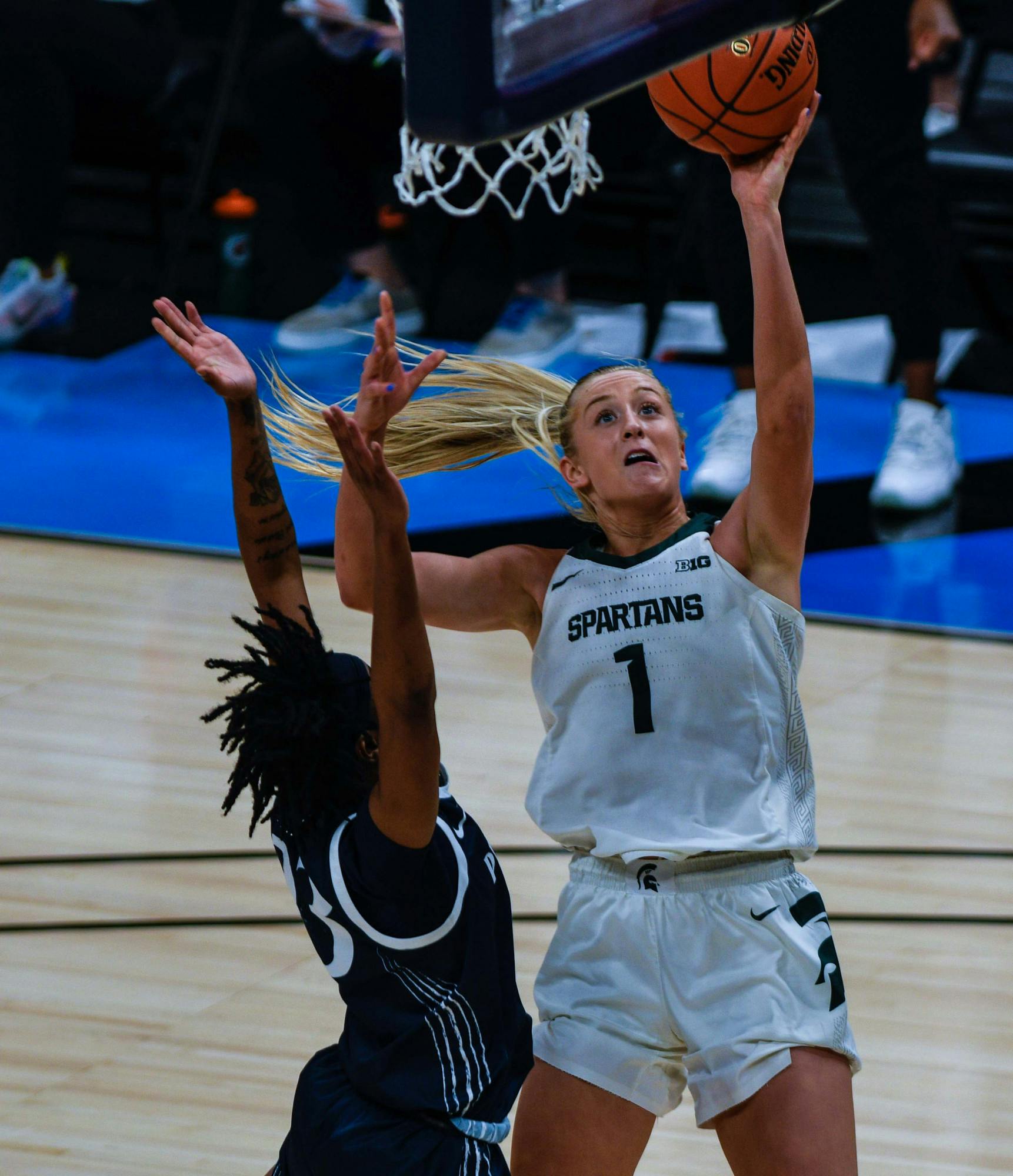 <p>Tory Ozment makes a face as she goes for the layup and realizes the Penn State player is too close. The Spartans defeated the Lady Lions, 75-66, on the second day of the Big Ten Tournament hosted at Bankers Life Fieldhouse in Indianapolis. Shot on March 10, 2021.</p>