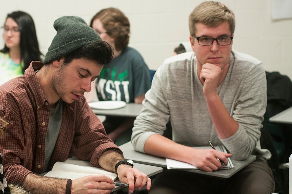 <p>International Relations senior, Eric Savoie, listens to a Physics junior, Kurt Hamel Jan. 15, 2015, during a meeting at Wells Hall. Students of several activist groups on campus gathered to discuss current issues in promoting their cause and future plans to promote change on campus. Kennedy Thatch/The State News</p>