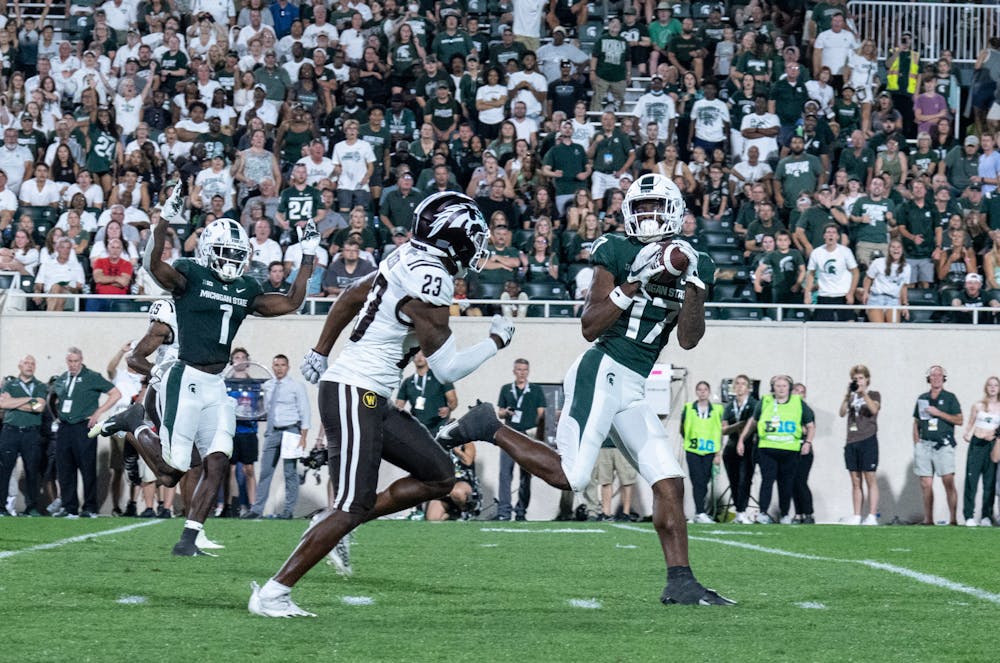 <p>Redshirt junior wide receiver Tre Mosley (17) completes a catch and scores a touchdown during game against Western Michigan on Sept. 2, 2022. The Spartans beat the Broncos with a score of 35-13.&nbsp;</p>