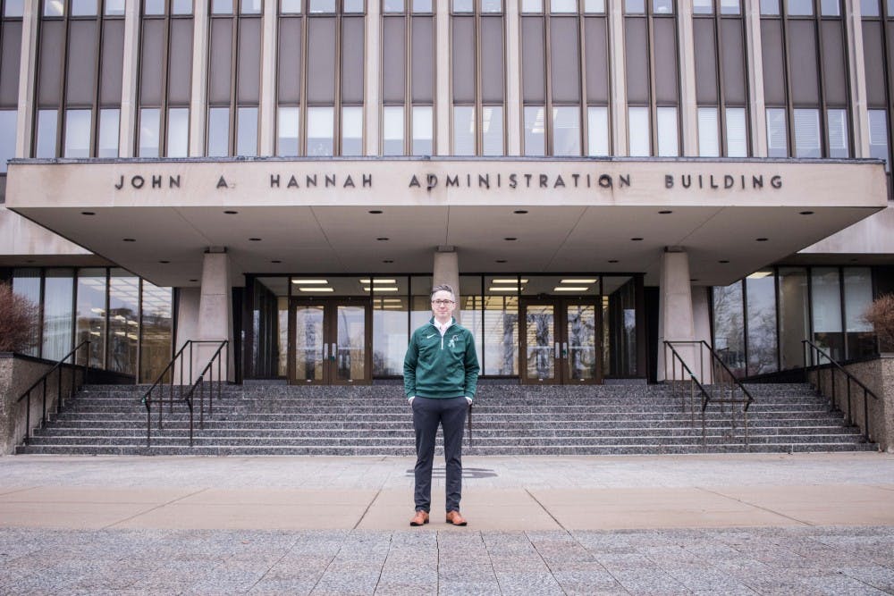 MSU Board of Trustees candidate Justin Johnson poses outside the Hannah Administration Building on Feb. 23, 2018.