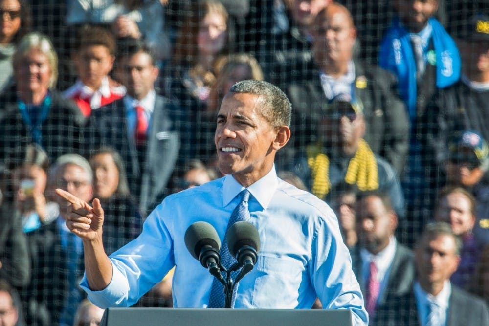 <p>President Barak Obama points to the crowed after speaking during a rally for Hillary Clinton on Nov. 7, 2016 at Ray Fisher Stadium at the University of Michigan. (State News File Photo)</p>