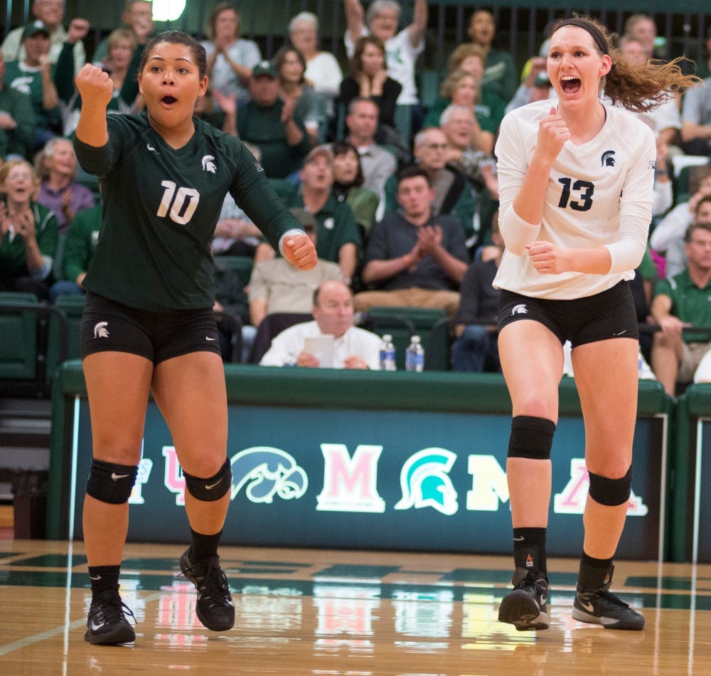 <p>Left to right, sophomore libero Abby Monson and sophomore middle back Brooke Kranda celebrate after a kill during the volleyball game against Ohio State on Oct. 21, 2015 at Jenison Field House. The Spartans defeated Ohio State, 3-0.</p>