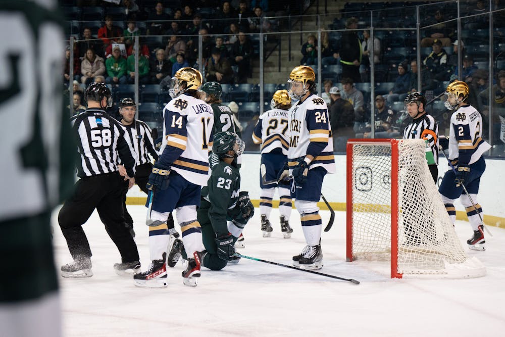 MSU forward Jagger Joshua looks up at Notre Dame defenseman Drew Bavaro after a collission in front of the net on Friday, March 3, 2023 at Compton Family Ice Arena in Notre Dame, Indiana. Notre Dame was the first to score during the matchup after a late second period goal.