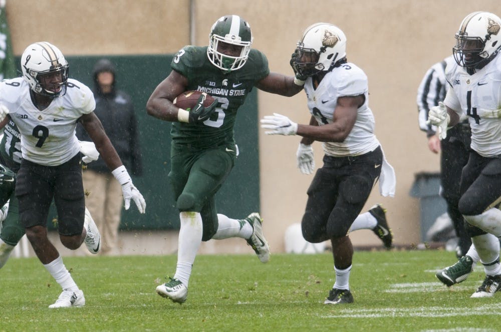 <p>Freshman running back LJ Scott stiff arms Purdue safety Leroy Clark during the third quarter of the Homecoming game against Purdue on Oct. 3, 2015 at Spartan Stadium. The Spartans defeated the Boilermakers, 24-21.</p>