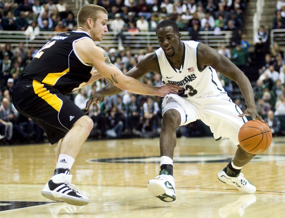 Senior forward Draymond Green drives the baseline during Wednesday's game against Milwaukee at Breslin Center. Green lead the Spartans in points with 18. Lauren Wood/The State News