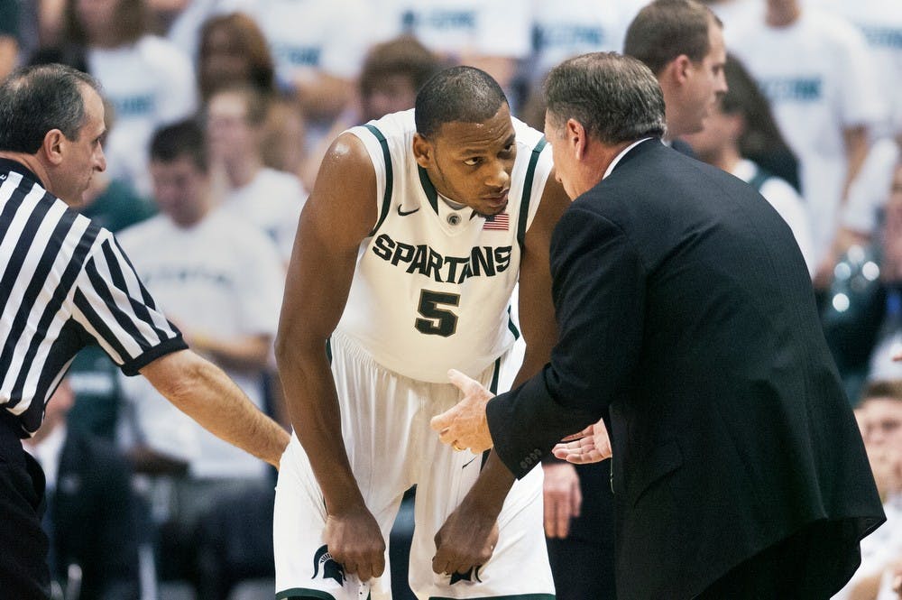 Junior center Adreian Payne talks with head coach Tom Izzo during a break in the game on Friday night, Nov. 2, 2012, at Breslin Center. The Spartans defeated St. Cloud State 62-49 in the second and final exhibition game of the season. Adam Toolin/The State News
